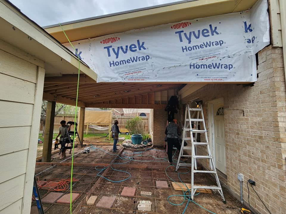 Home under construction with Tyvek wrap on covered patio