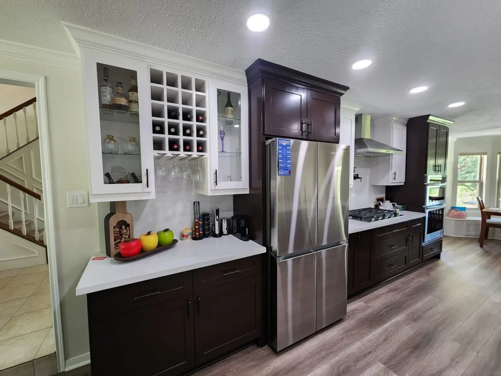Contemporary kitchen with white countertops and dark cabinets