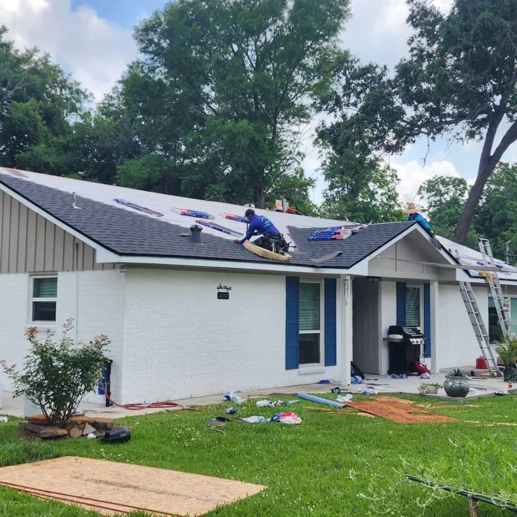 Exterior home renovation with new white siding and roof upgrade